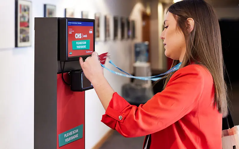 person scanning their badge at a ScanPod