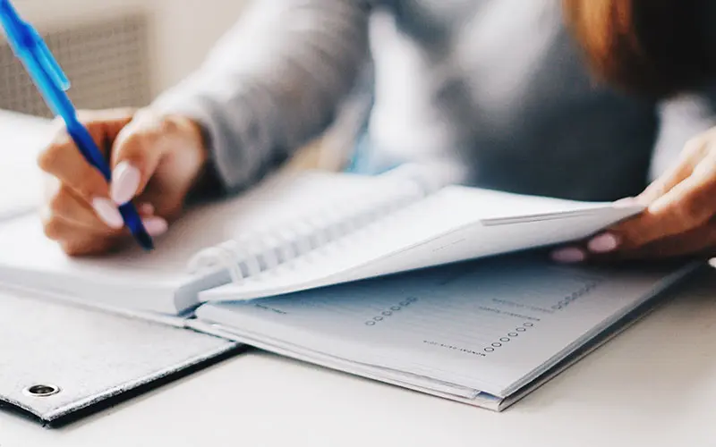 Person writing a list