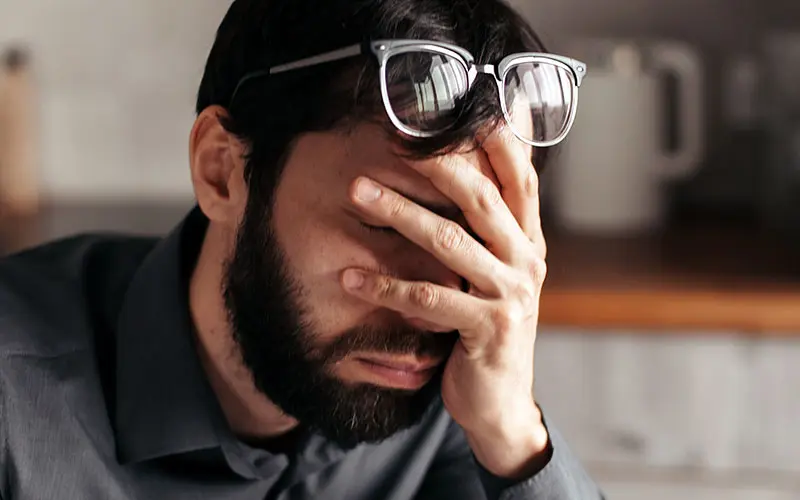 Man with his head in his hand