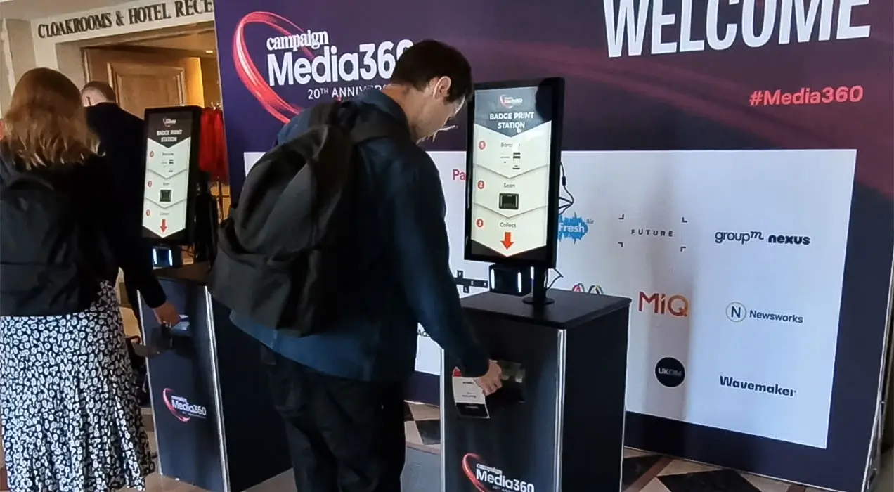 Person collecting badge from PrintPod