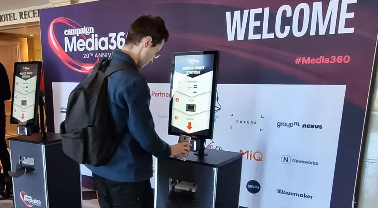 Person scanning barcode on their phone at a Printpod