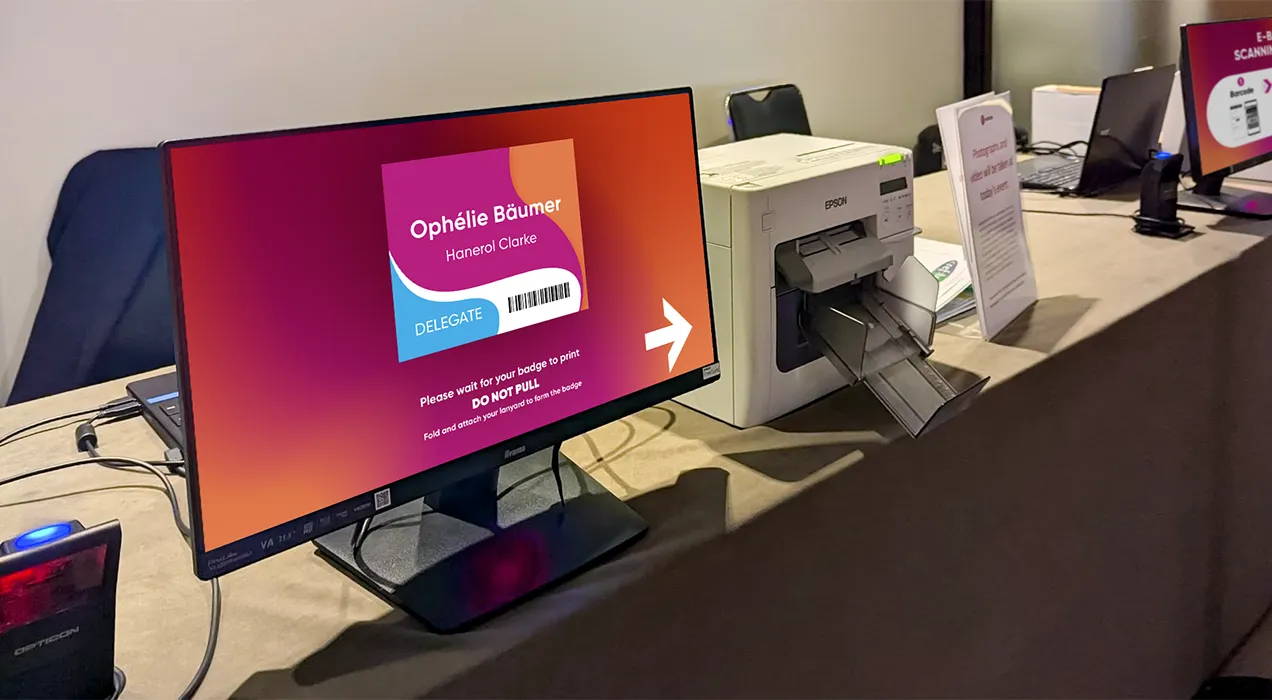 Badge preview screen with scanner and printer showing badges